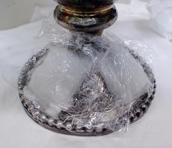 Cleaning the base of Geometric Ewer A with an alkaline-glycerine wrap    